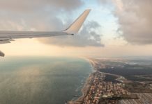 The Dip: How to Dress and Drink on a Flight plane flying over city